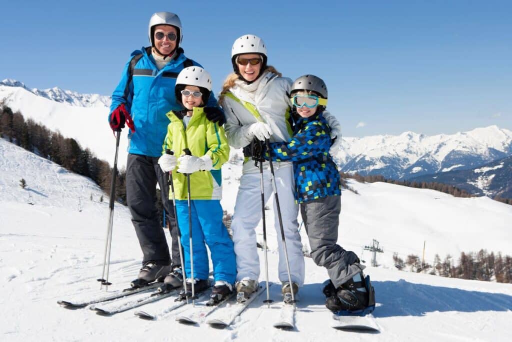 rodzina na stoku ubrania w stylową odzież narciarską